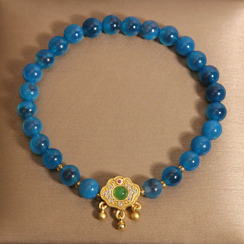 Blue sugar heart agate safety lock pendant on a women's crystal bracelet with alloy inlay and rhinestones.