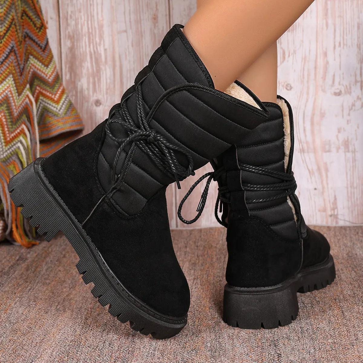 Women's black suede snow boots with chunky heel, fleece lining, and lace-up design for winter wear