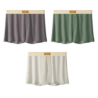 Pack of three pairs of solid colour men's ice silk briefs on a white background