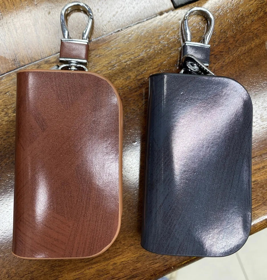 Genuine leather car key case with zipper closure showing black and brown colour options
