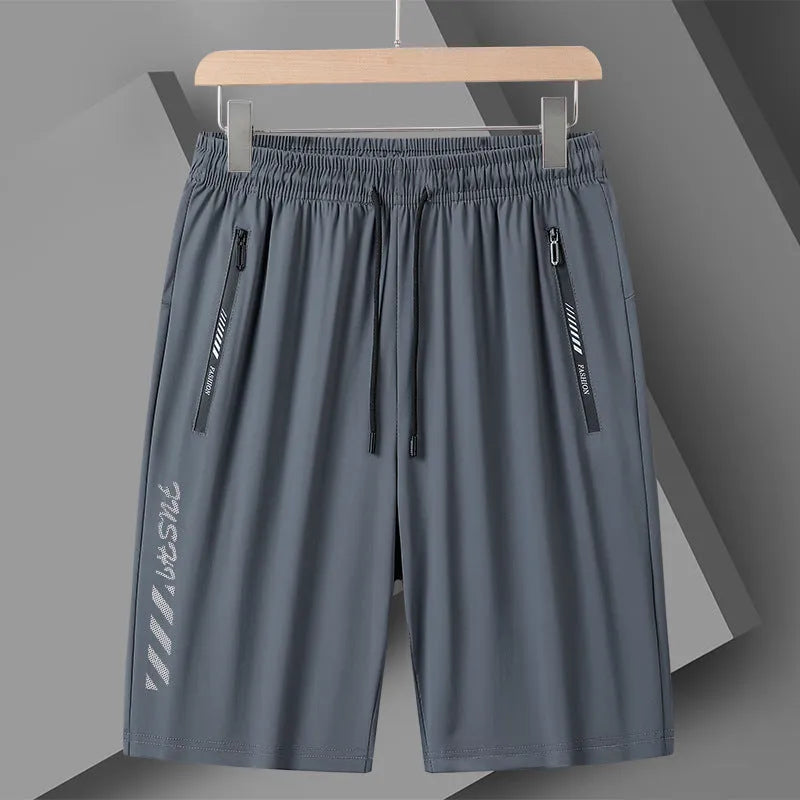 Man wearing black loose-fit quick-dry nylon sports shorts with an elastic waistband.