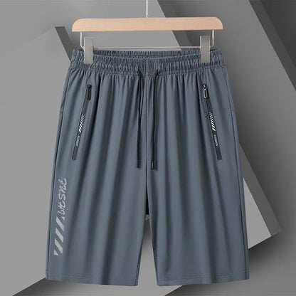 Man wearing black loose-fit quick-dry nylon sports shorts with an elastic waistband.