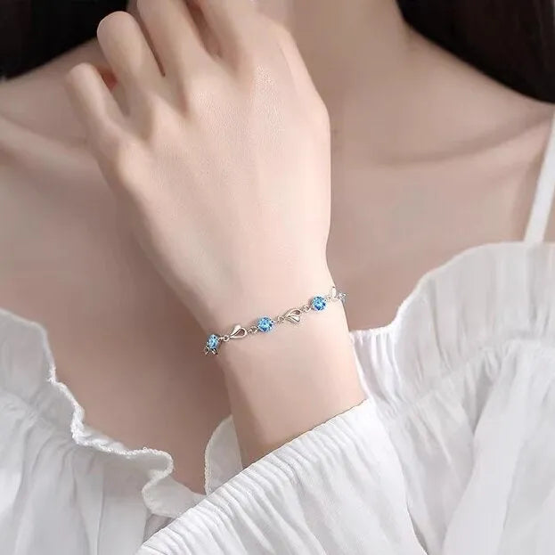 Blue diamond heart-shaped pendant necklace and matching bracelet set on a copper chain.