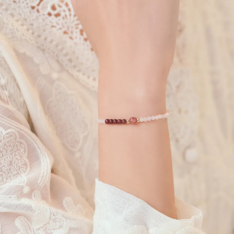 Handmade pink crystal bracelet with strawberry quartz charm showing 2mm beads