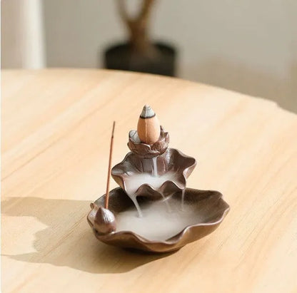 Square ceramic incense burner with reverse flow design showing smoke cascading down sides, Ge kiln crackle glaze patterns visible
