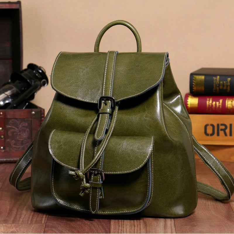 Korean style cowhide backpack with front sandwich pockets and internal zipped compartments, measuring 28 x 30 x 12 cm, available in black, brown, coffee, and grass green colour options