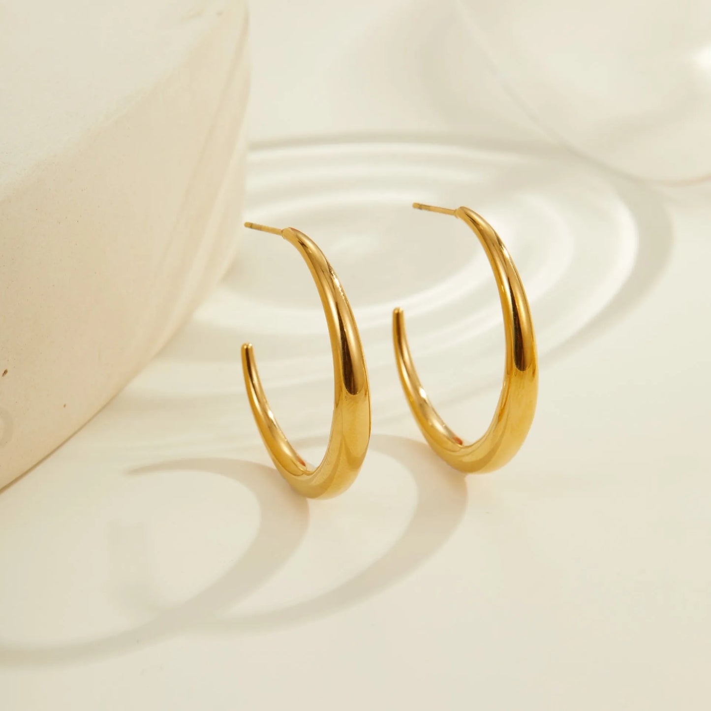 Titanium steel geometric round hoop earrings with 18K gold plating available in large and small sizes