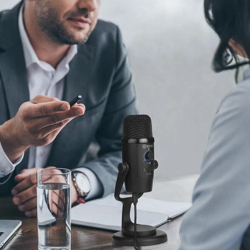 Black Boya BY-PM500 USB microphone with built-in sound card on a desktop.