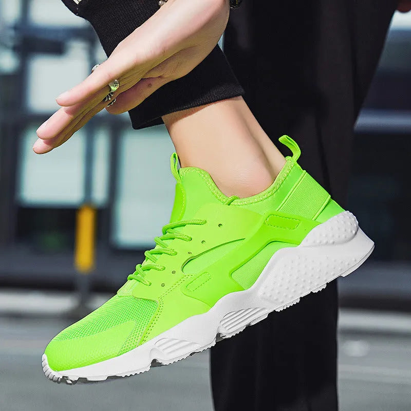 Men's low top casual shoes with mesh upper, cross shoulder straps, and flat heel in fluorescent colours
