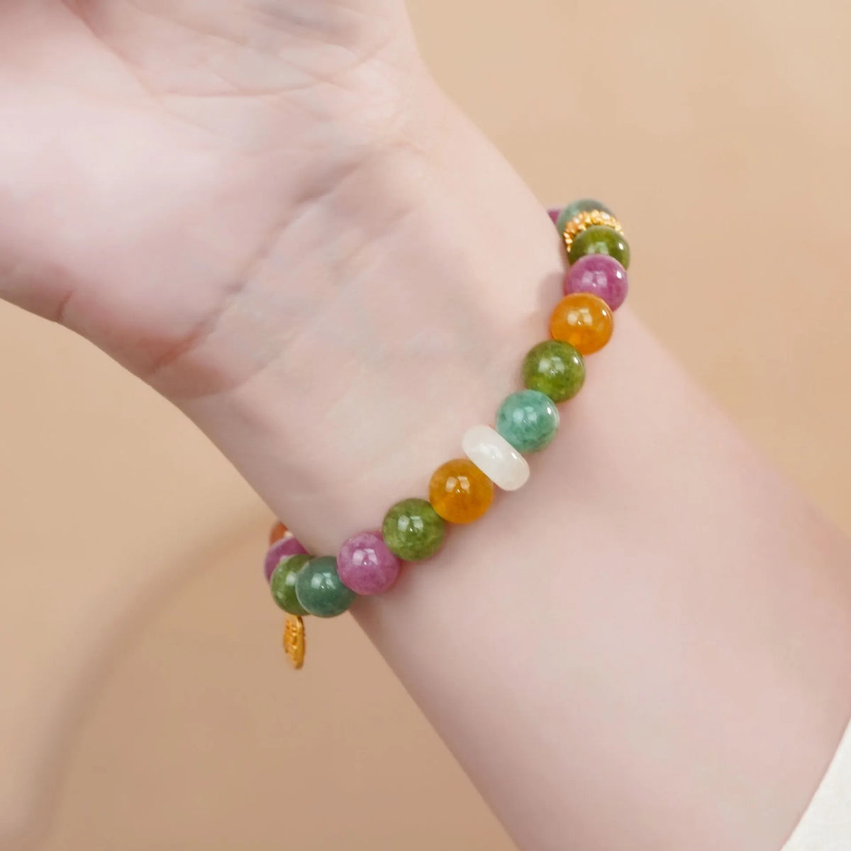 Rainbow-coloured tourmaline half bracelet for women on a wrist.
