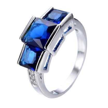 Aier Moxa geometric copper fashion ring in assorted electroplated colours on a plain background.