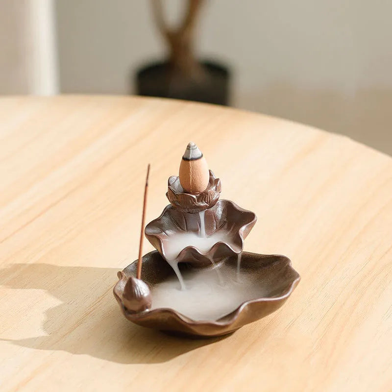 Square ceramic incense burner with reverse flow design showing smoke cascading down sides, Ge kiln crackle glaze patterns visible