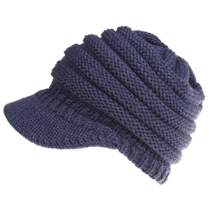Women's acrylic knitted ponytail beanie in a solid colour, shown on a model with a ponytail.