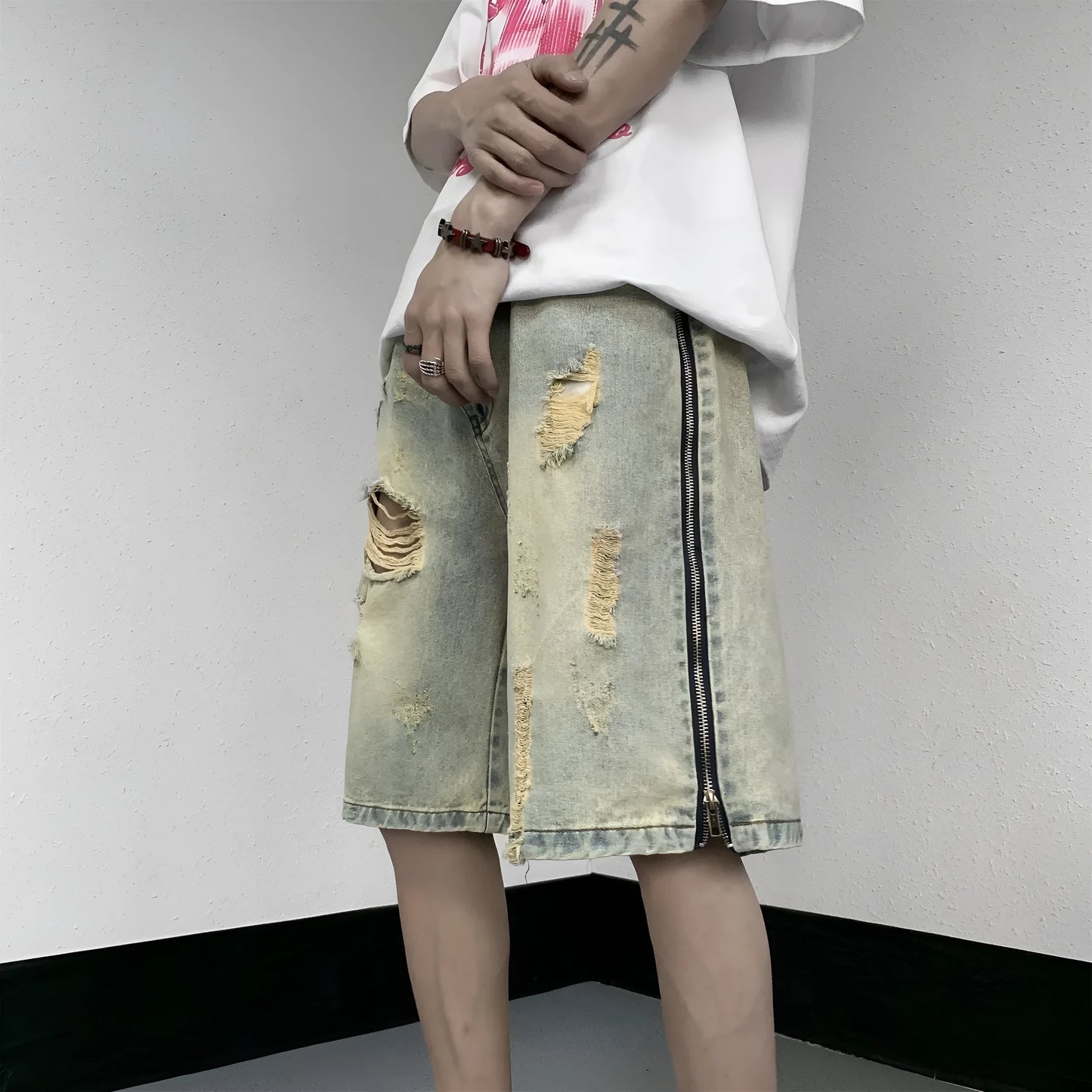 Men's blue denim shorts with retro yellow mud ripped detailing and button-front cardigan closure