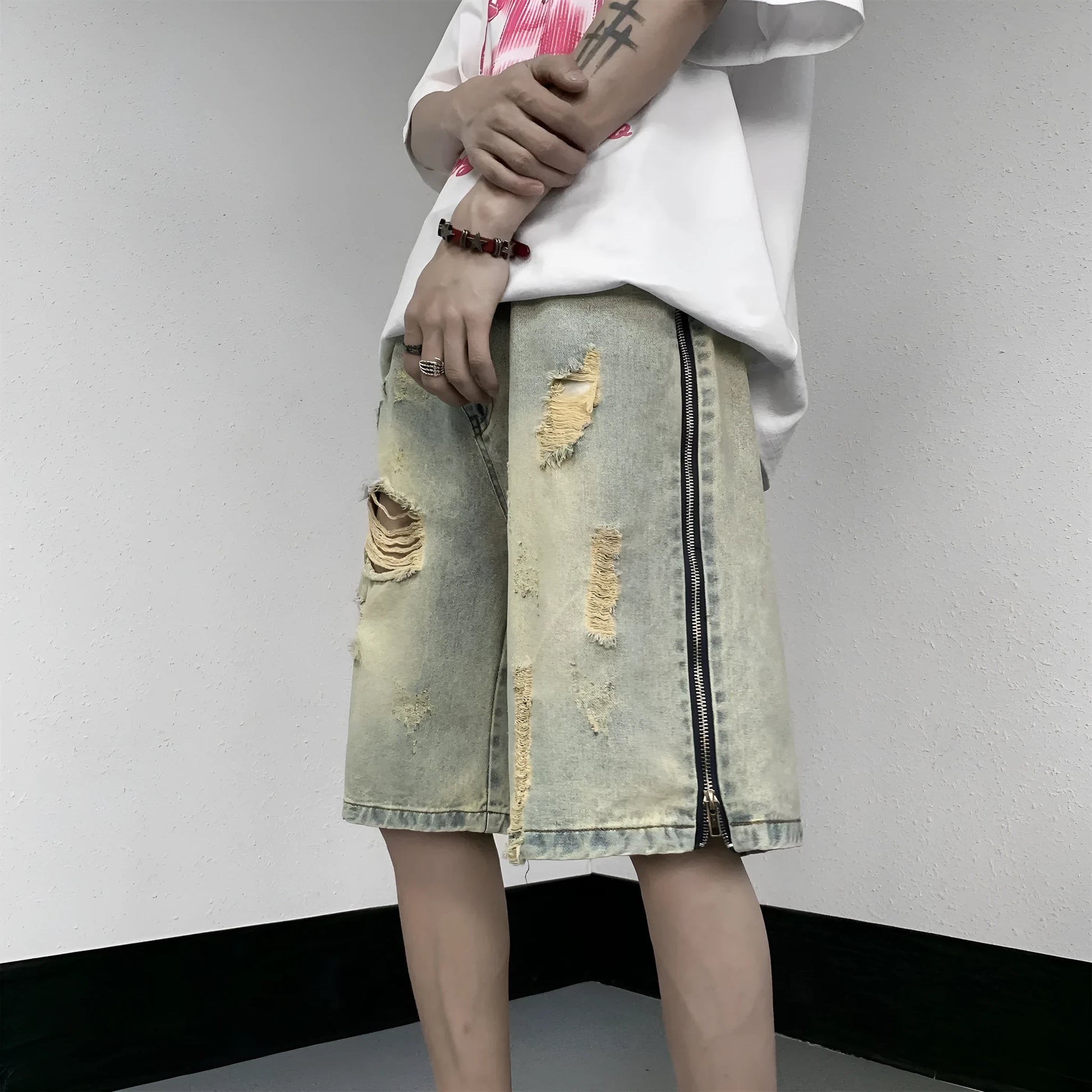 Men's blue denim shorts with retro yellow mud ripped detailing and button-front cardigan closure