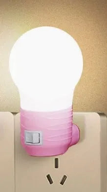 Plug-in bedside baby night light in white, blue, or pink shell with round shape.