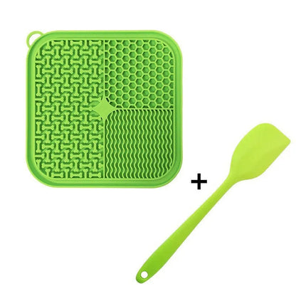 Square orange, grey, blue, and green silicone dog licking mat with suction cups on the base.