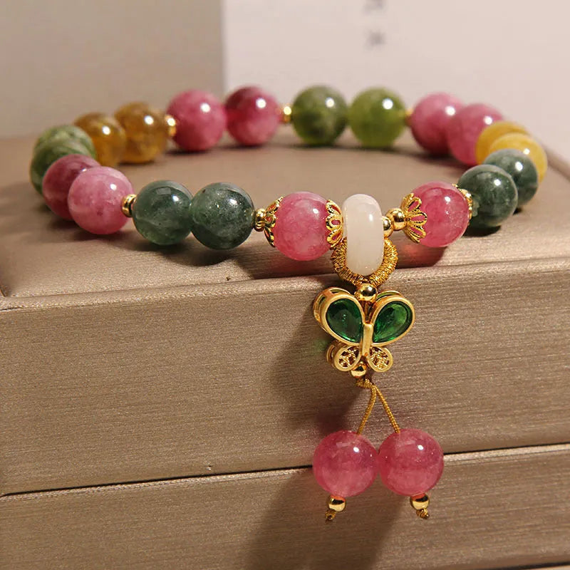 Tourmaline bracelet for women with a colourful butterfly pendant featuring natural jade colour tourmaline and rhinestone decoration in an alloy inlay setting with artificial gemstone or semi-precious stone components.