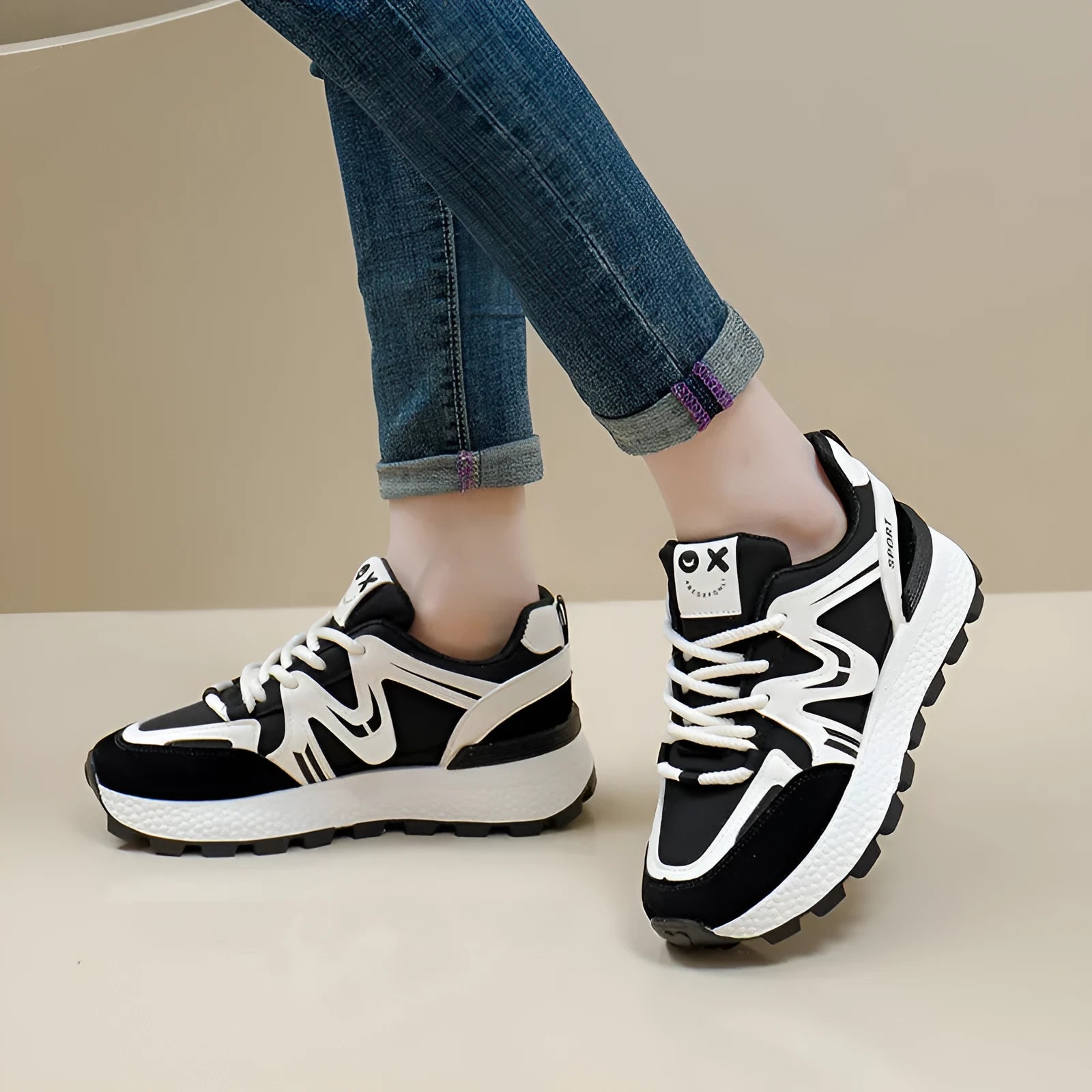 Women's black sports casual shoes with round toe and front lace-up design on a flat heel.