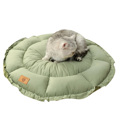 Reversible circular donut cat bed in grey and green colours showing raised outer rim