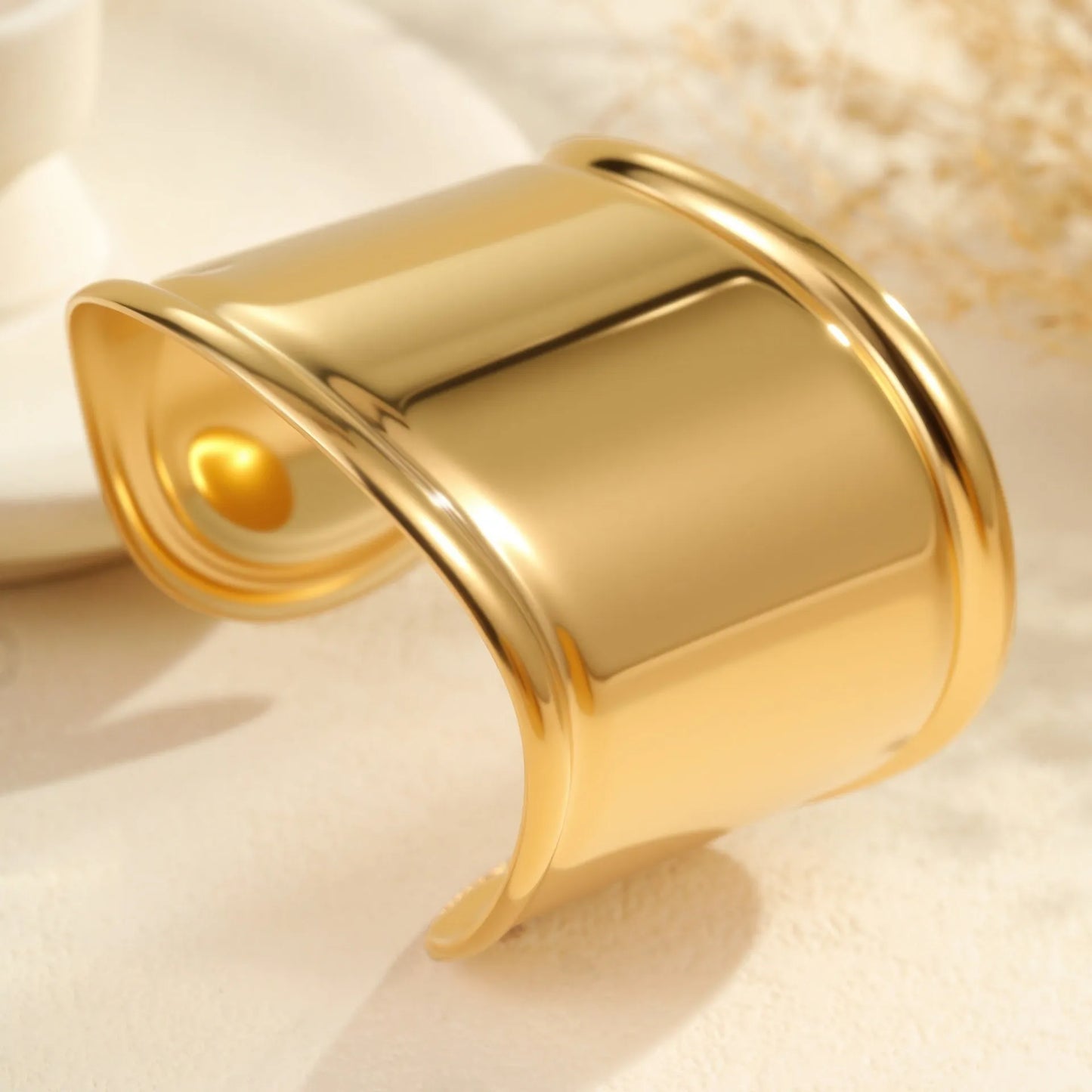 Women's stainless steel bracelet with 18K gold plating featuring exaggerated wide geometric wave design and niche opening