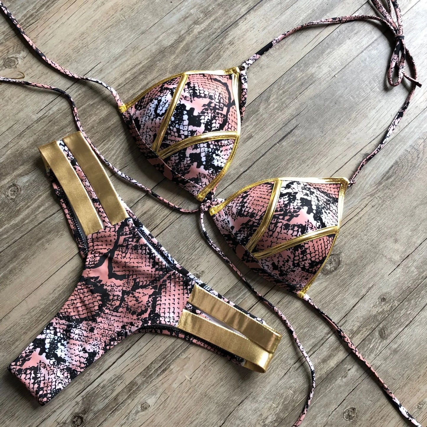 Women's bronzing bikini with padded cups in a selection of colours including black, blue, leopard print, and snakeskin print.