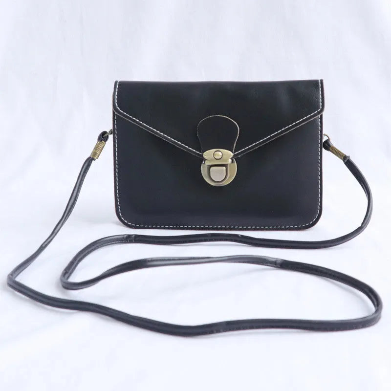 Retro shoulder messenger bag in cross square shape with flap and lock closure, showing internal mobile phone compartment