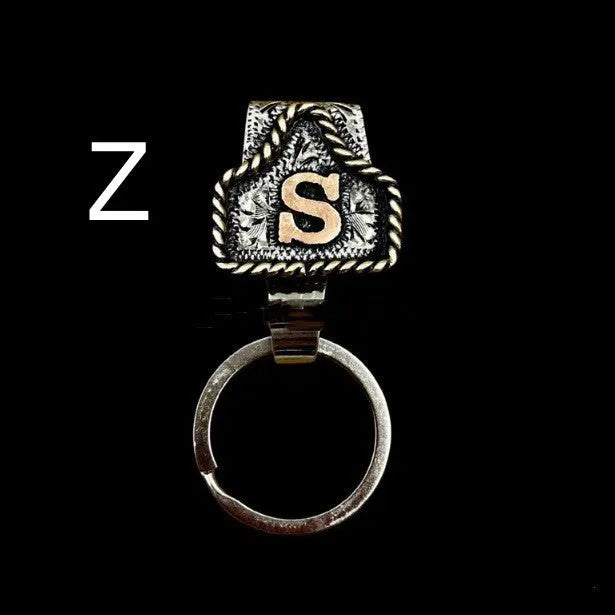 Handmade cow tag design metal keychain on a keyring, shown in one of many available colours.
