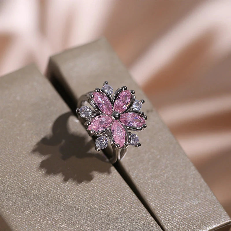 Dazzling cubic zirconia jewellery set with double-layered flower design, including ring, necklace, and earrings in pink and white diamond colours