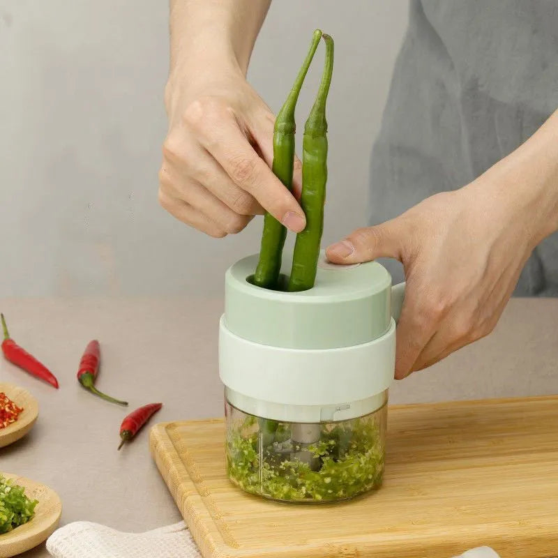 Wireless electric garlic masher and slicer combo, plastic body, 18.5cm x 13.1cm x 9.38cm, with Type-C cable and manual.