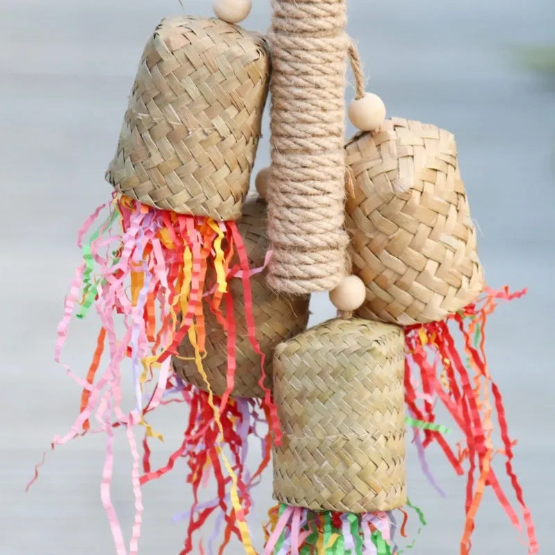Natural wood and sisal rope shredded paper parrot activity toy measuring 15 by 35 centimetres.