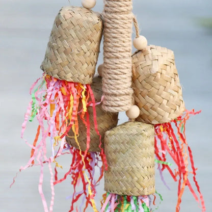 Natural wood and sisal rope shredded paper parrot activity toy measuring 15 by 35 centimetres.