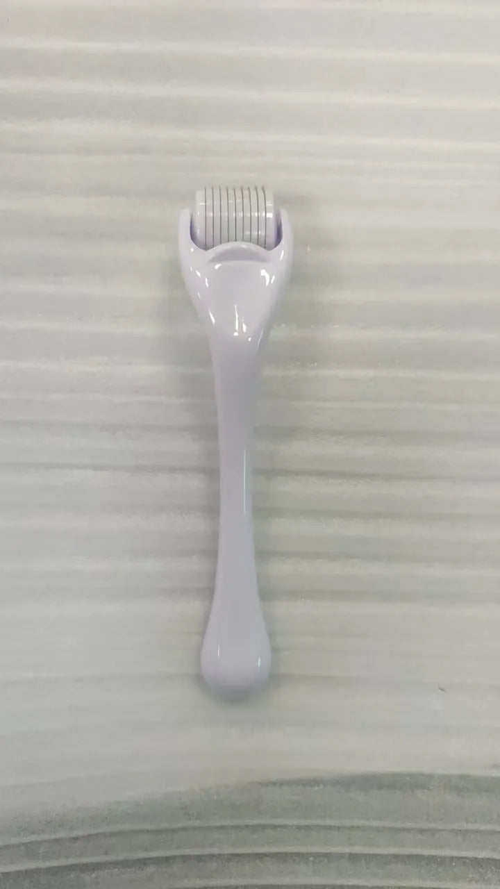 Sterile micro needle derma roller with black handle and coloured wheel on white background