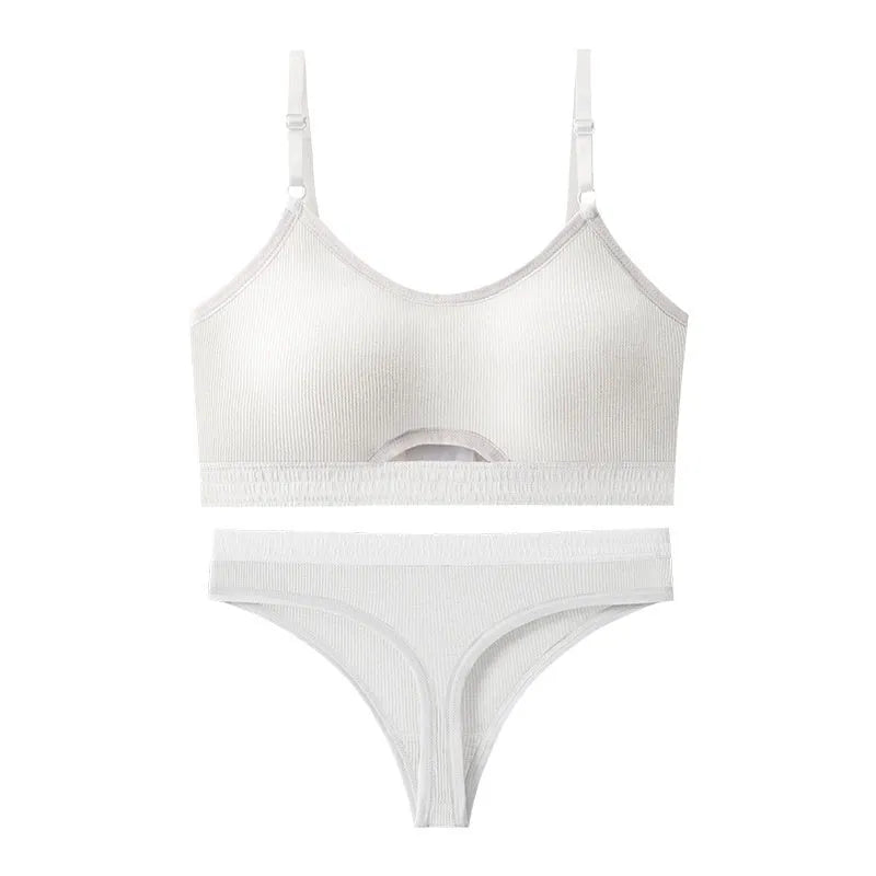 White underwired sports bra set with contrast dark grey back detailing and matching briefs on a mannequin.