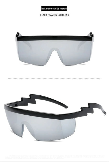 Black one-piece cycling sunglasses with blue polycarbonate lenses and lightning leg temples on a grey background.