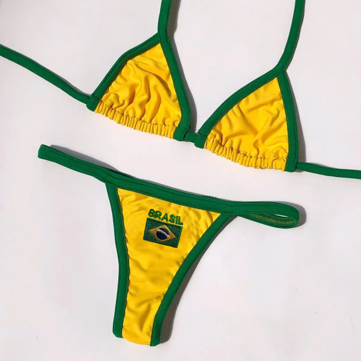 Women's yellow polyester bikini set with T-back bra and matching shorts on a mannequin
