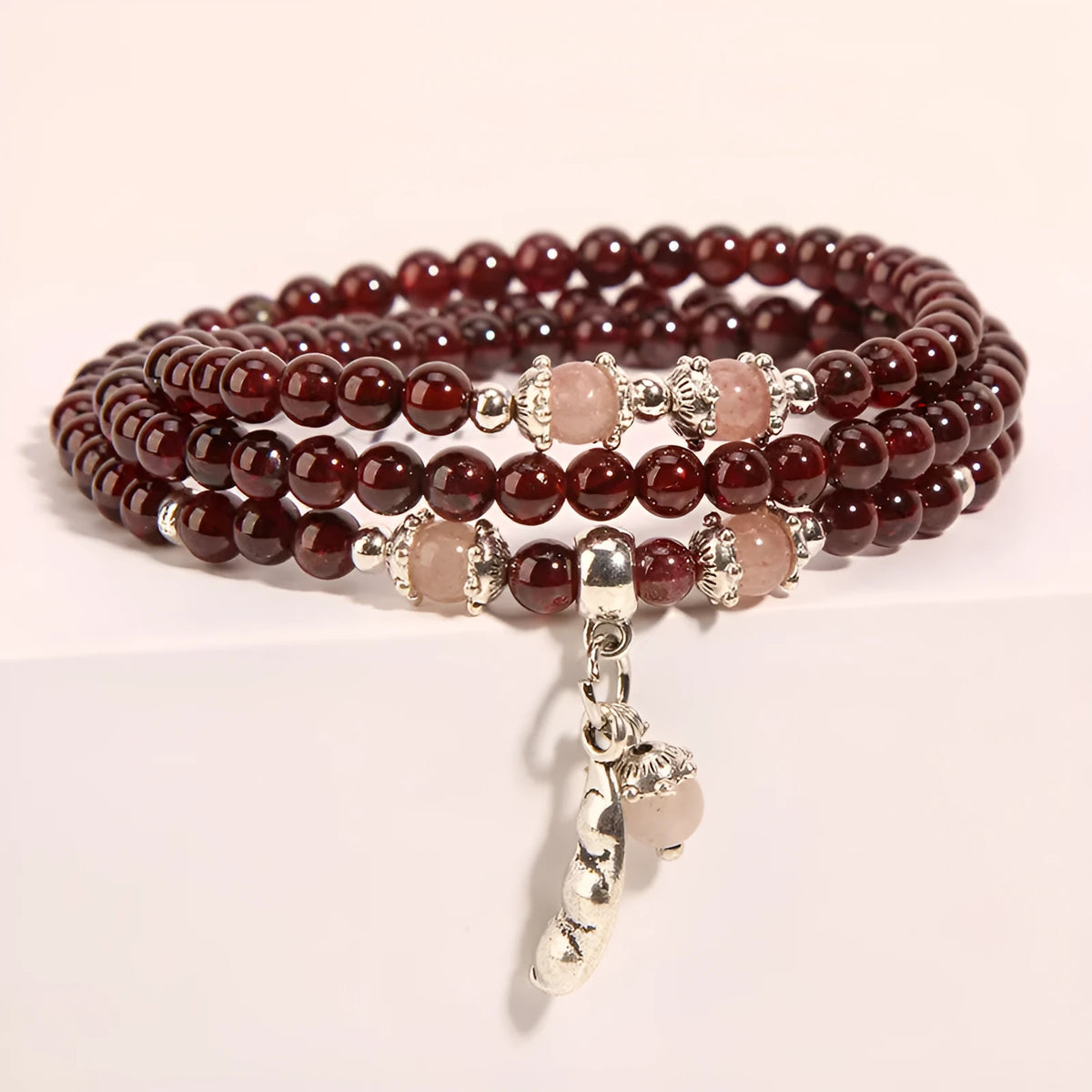 Women's crystal floral bracelet with wine red garnet stones and sauteed green beans detailing