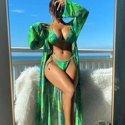 Polyester banded bikini set with long sleeve blouse, briefs, and robe cover-up in floral pattern