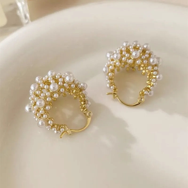 Gold-coloured women's floral basket earrings made from copper with small bead and pearl inlay detail.