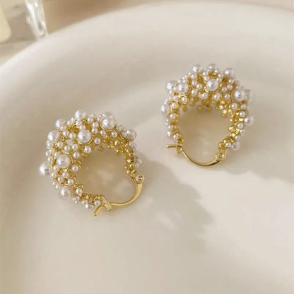 Gold-coloured women's floral basket earrings made from copper with small bead and pearl inlay detail.