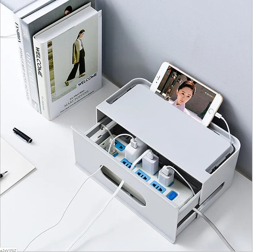 A grey and a white plastic storage box for organising a wireless router and its cables.