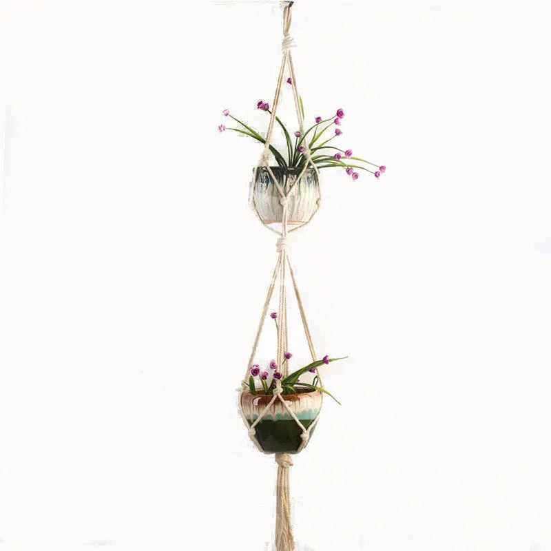 Galvanised steel wire plant basket with open grid, holding a green potted succulent on a wooden table.