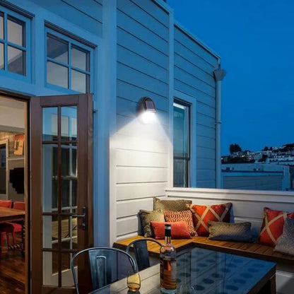 Black rectangular LED solar wall light with solar panel on top for outdoor security.