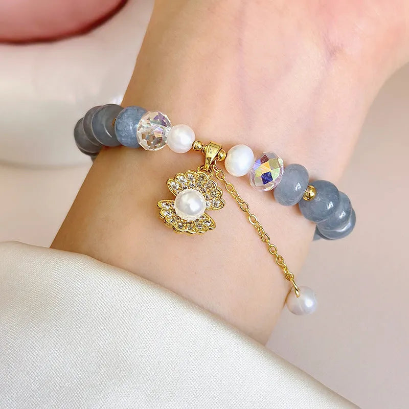 Natural aquamarine pearl bracelet with abalone shell charms on adjustable cord