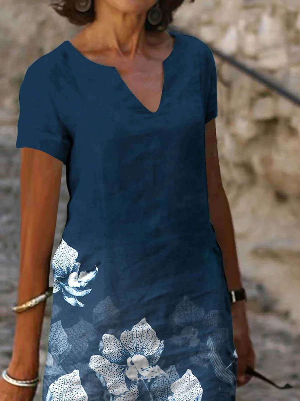 Elegant floral-printed cotton and linen midi dress in various colours with short sleeves and v-neck