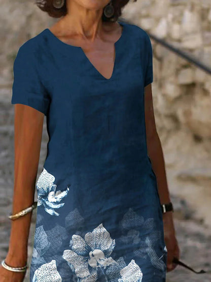 Elegant floral-printed cotton and linen midi dress in various colours with short sleeves and v-neck