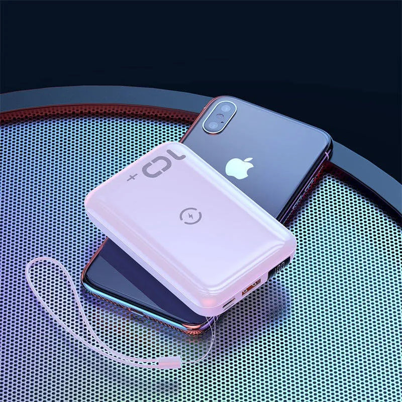 Small square black wireless charging power bank with LED display showing battery percentage.
