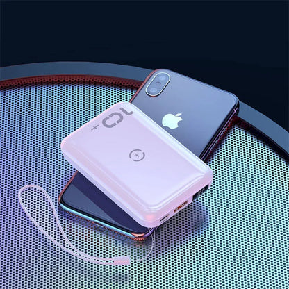 Small square black wireless charging power bank with LED display showing battery percentage.