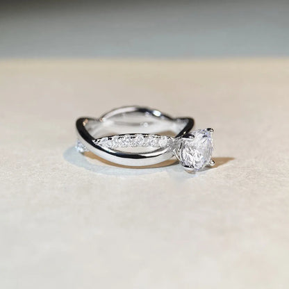 Geometric silver ring with winding twisted arm and 1 karat moissanite stone in four-claw setting
