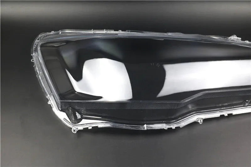 Transparent plastic car headlight housing cover with dimensions 50mm by 30mm by 20mm.